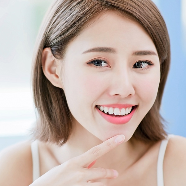 A girl smiling after her laser therapy at Periodontal Surgical Arts.